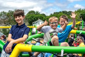 three children playing at the inclusive playground